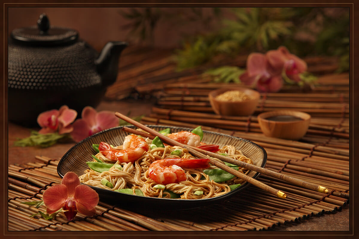Shrimp pea pod noodles Japanese food chopsticks bamboo mat orchids Asian oriental traditional