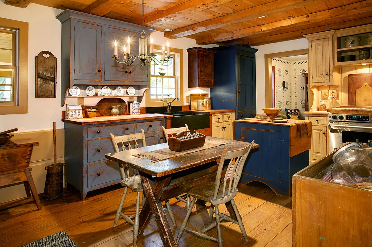 Primitive colonial style residence kitchen dining table reproduction antiques architectural interior cabinets authentic modern Illinois