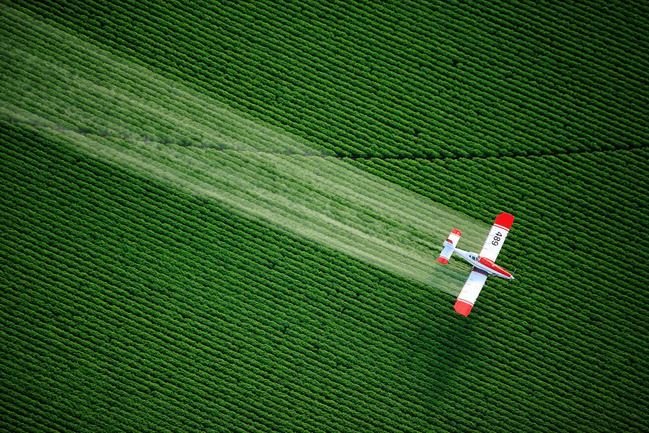 farming potato agriculture pollution farm aerial view crop duster application airplane crop sprayer chemicals