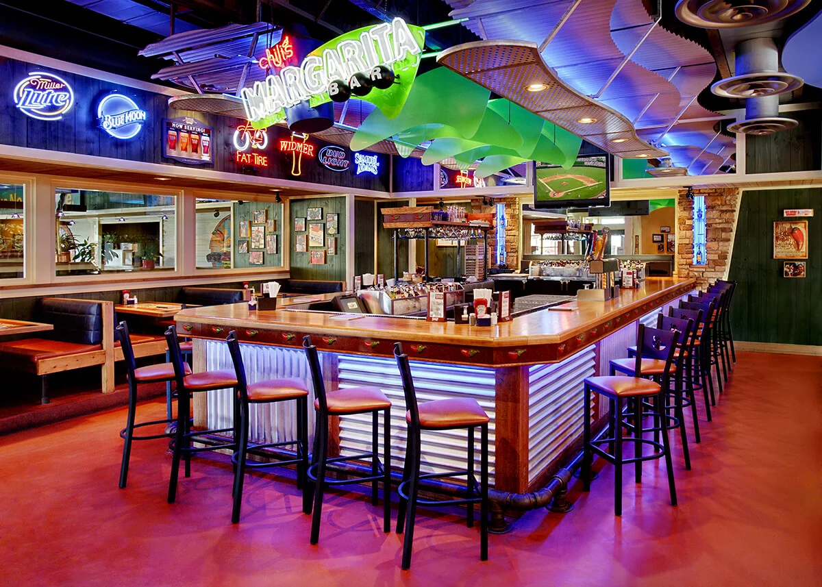 Chilies Margarita bar pub interior architecture colorful neon signs restaurant tables lounge atmosphere